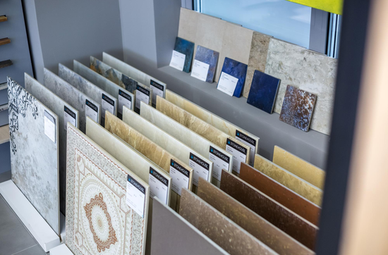 Tile showroom display featuring ceramic and porcelain tile samples in various designs