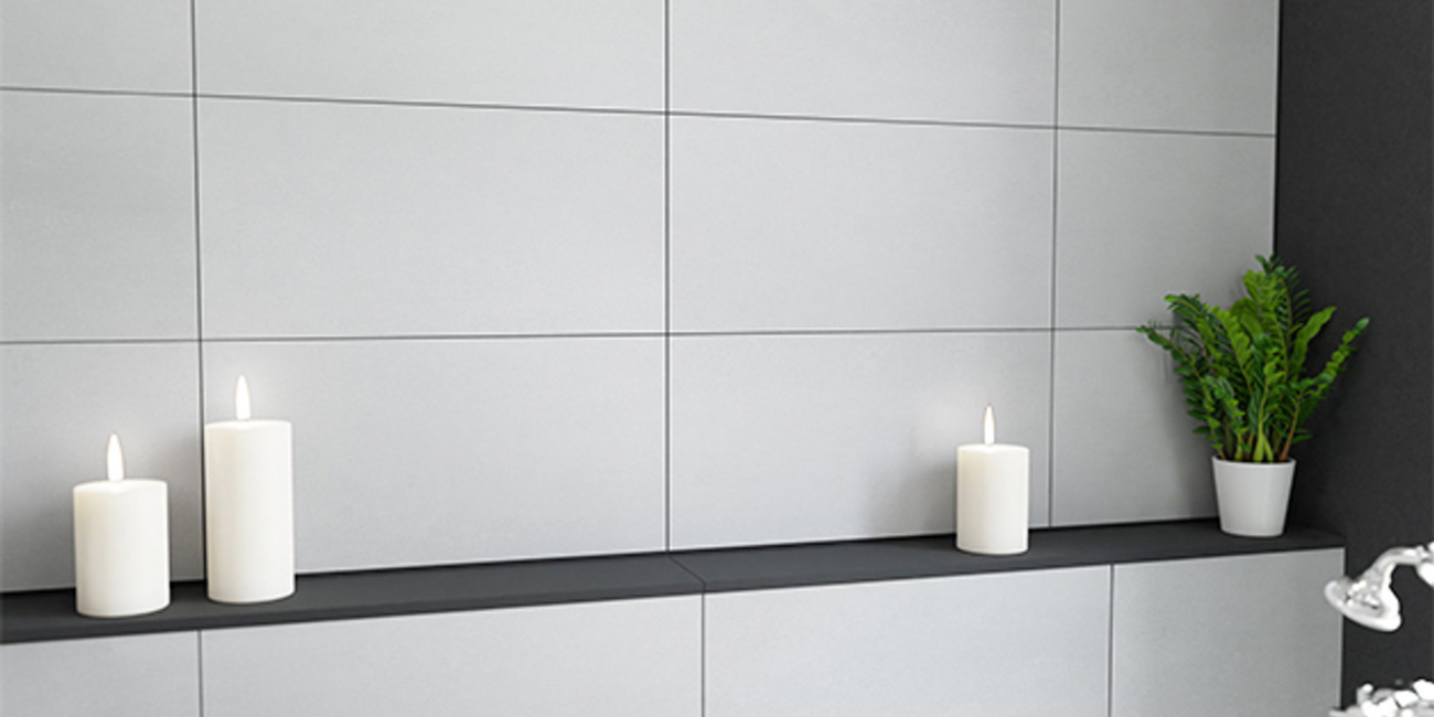 Smooth grey wall tiles with candles and plant decor in modern interior