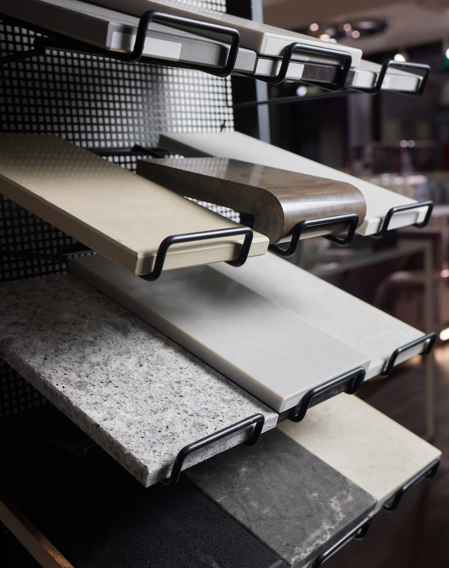 Tile and stone sample display showing various flooring and countertop material options