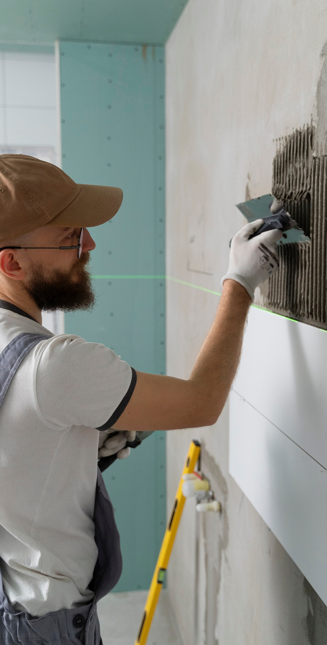 Los Angeles Tiles Worker installing Tiles on a wall in a house in LA